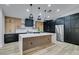 Modern kitchen with wood and black cabinets and large island at 160 Swale Ln, Las Vegas, NV 89144