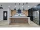 Modern kitchen with wood and black cabinets, large island, and stainless steel appliances at 160 Swale Ln, Las Vegas, NV 89144