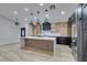 Modern kitchen with a large island, quartz countertops, and dark cabinetry at 160 Swale Ln, Las Vegas, NV 89144