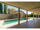 Relaxing pool area with covered patio and lush landscaping at 160 Swale Ln, Las Vegas, NV 89144