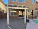 Covered patio with pergola adjacent to the pool at 1762 Sunflower Ct, Henderson, NV 89074