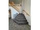 Gray carpeted staircase with wood railing at 1762 Sunflower Ct, Henderson, NV 89074