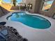 Freeform swimming pool with surrounding concrete decking at 1762 Sunflower Ct, Henderson, NV 89074