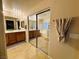 Bathroom with large mirror reflecting the bathtub and vanity at 1908 W Hammer Ln, North Las Vegas, NV 89031