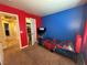 Red and blue bedroom with a twin bed, closet access, and TV at 1908 W Hammer Ln, North Las Vegas, NV 89031