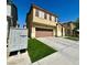 Two-story house with artificial turf and a community mailbox at 1908 W Hammer Ln, North Las Vegas, NV 89031