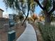 Community park path with pet waste station and mature trees at 1908 W Hammer Ln, North Las Vegas, NV 89031