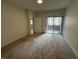 Inviting bedroom features carpeted floors and sliding glass door to patio at 2001 Jasper Bluff St # 102, Las Vegas, NV 89117