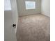 Bright, carpeted bedroom featuring a large window that provides natural light and neutral walls at 2001 Jasper Bluff St # 102, Las Vegas, NV 89117