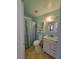 Bathroom with white vanity, toilet, and teal walls at 2102 E Russell Rd, Las Vegas, NV 89119