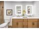 Bright bathroom with double vanity, lighted mirrors, and modern fixtures at 2500 W Oakey Blvd, Las Vegas, NV 89102