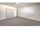 Simple bedroom with gray carpet, double doors leading to a bathroom, and plenty of closet space at 2500 W Oakey Blvd, Las Vegas, NV 89102