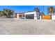 Single-story home with a newly renovated exterior and a gravel driveway at 2500 W Oakey Blvd, Las Vegas, NV 89102