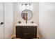 Modern bathroom with floating vanity and round mirror at 2781 Sandyfalls Way, Las Vegas, NV 89142