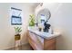 Modern bathroom with floating vanity, unique mirror, and plants at 2781 Sandyfalls Way, Las Vegas, NV 89142