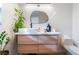 Modern bathroom with floating vanity, unique mirror, and plants at 2781 Sandyfalls Way, Las Vegas, NV 89142