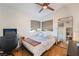 Bright bedroom with a queen bed, workspace, and wood floors at 2781 Sandyfalls Way, Las Vegas, NV 89142