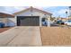 Single-story home with a dark gray garage door and rock landscaping at 2781 Sandyfalls Way, Las Vegas, NV 89142