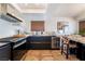 Modern kitchen with stainless steel appliances and dark cabinetry at 2781 Sandyfalls Way, Las Vegas, NV 89142