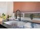 Modern kitchen with black sink and faucet, and cellular shade at 2781 Sandyfalls Way, Las Vegas, NV 89142