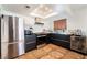 Modern kitchen with stainless steel appliances and dark cabinetry at 2781 Sandyfalls Way, Las Vegas, NV 89142