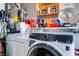 Laundry room with washer, dryer, and storage shelves at 2781 Sandyfalls Way, Las Vegas, NV 89142