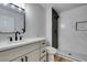 Modern bathroom with gray tile, white vanity, and walk-in shower at 2856 Billy Casper Dr, Las Vegas, NV 89134