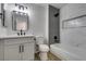 Modern bathroom with gray and white tile, a white vanity, and a bathtub at 2856 Billy Casper Dr, Las Vegas, NV 89134