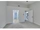 Spacious bedroom with grey carpet and access to hallway and kitchen at 2856 Billy Casper Dr, Las Vegas, NV 89134