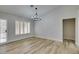 Bright dining room with chandelier, wood-look floors, and plantation shutters at 2856 Billy Casper Dr, Las Vegas, NV 89134