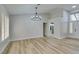 Bright dining room with chandelier, wood-look floors, and plantation shutters at 2856 Billy Casper Dr, Las Vegas, NV 89134