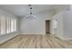 Bright dining room with chandelier, wood-look floors, and plantation shutters at 2856 Billy Casper Dr, Las Vegas, NV 89134