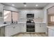 Modern kitchen with white cabinets, stainless steel appliances at 2856 Billy Casper Dr, Las Vegas, NV 89134