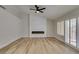 Living room with fireplace, wood-look floors, and ceiling fan at 2856 Billy Casper Dr, Las Vegas, NV 89134