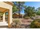 Back patio with gravel landscaping and desert trees at 2856 Billy Casper Dr, Las Vegas, NV 89134