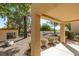 Covered patio with view of landscaped backyard and surrounding trees at 2856 Billy Casper Dr, Las Vegas, NV 89134