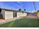 Artificial turf backyard with a large patio and a concrete slab at 3225 Crawford St, North Las Vegas, NV 89030