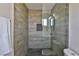 Updated bathroom with glass shower enclosure and wood-look tile at 3225 Crawford St, North Las Vegas, NV 89030