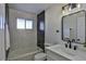 Bathroom with a bathtub, modern vanity, and marble tile at 3225 Crawford St, North Las Vegas, NV 89030