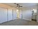 Bedroom with ceiling fan, neutral paint, carpet and en-suite bathroom at 3225 Crawford St, North Las Vegas, NV 89030