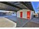 Carport with attached storage and a bright red door at 3225 Crawford St, North Las Vegas, NV 89030