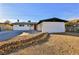 House exterior with a red door, rock landscaping, and a spacious yard at 3225 Crawford St, North Las Vegas, NV 89030