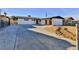 House exterior with a red door and a long driveway at 3225 Crawford St, North Las Vegas, NV 89030