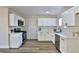 Modern kitchen with white cabinets, quartz countertops, and stainless steel appliances at 3225 Crawford St, North Las Vegas, NV 89030