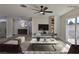 Modern living room features hardwood floors, a large TV, and plenty of natural light at 3225 Crawford St, North Las Vegas, NV 89030