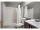 Clean bathroom with white tub and dark vanity at 332 Oakford St, Las Vegas, NV 89110