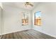 Bedroom with wood-look flooring, ceiling fan, and large windows at 332 Oakford St, Las Vegas, NV 89110