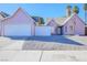 Two-toned house with double garage and gravel driveway at 332 Oakford St, Las Vegas, NV 89110