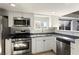 Bright kitchen features stainless steel appliances and white cabinetry at 332 Oakford St, Las Vegas, NV 89110