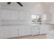 White kitchen with ample cabinetry, tile flooring and dishwasher at 3606 Altar Rock Ln, North Las Vegas, NV 89032